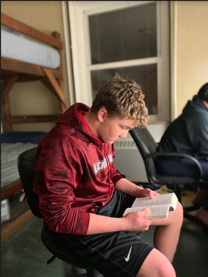 Reading a book for class during evening study hall, Nick Wehbe 21 relaxes after finishing homework. Wehbe transferred from Elkhorn South.