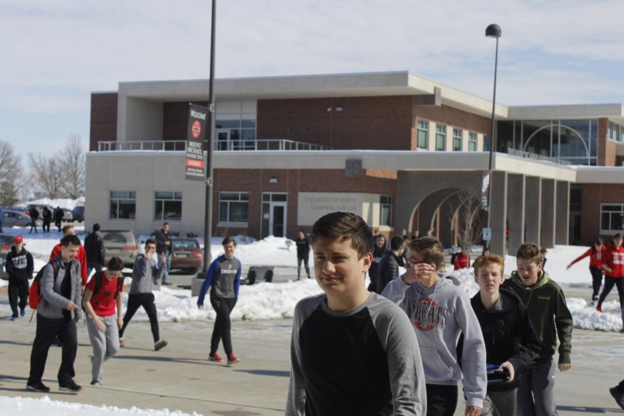 Ben Keller 21 along with other sophomores and freshmen walk across the parking lot to the Saint Benedict Building for lunch. The large amount of snow this winter has effected several aspects of campus life including getting to and from school.