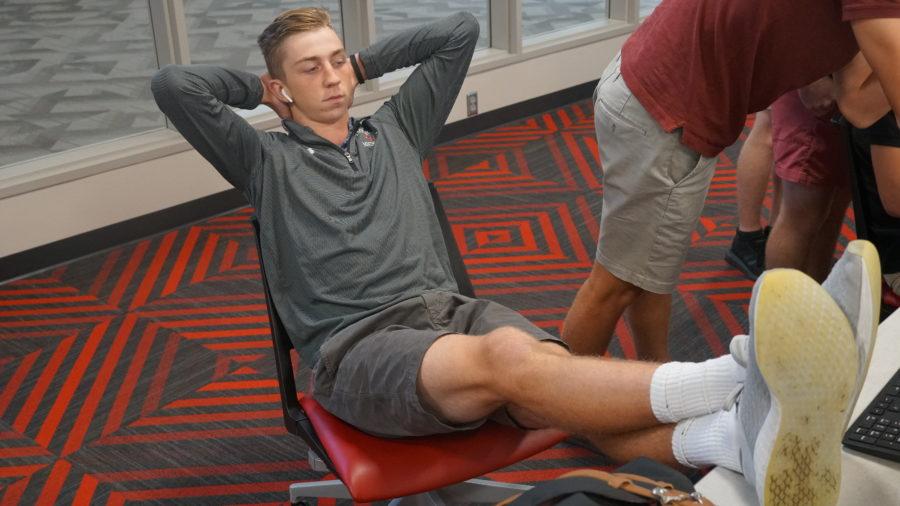 Michael Kremer 20 kicks back in Journalism class as other students collaborate. Kremer can be seen relaxing throughout the day in the majority of his classes.
