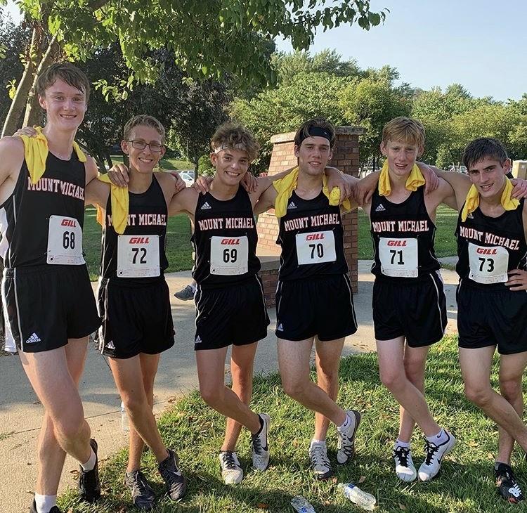 Cameron Mallisee ‘21, Jack Sorensen '21,  Ryan McMahon ‘21, John Schroll ‘20, Mark Schroll ‘22, and  Sam Wooten ‘20 hold on to one another after a hard-fought victory. The Cross country team plans on many more victories throughout the remainder of the season.