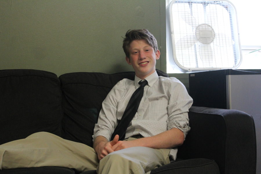 Henry Gnann 21 lounges on a comfy couch in his dorm. The juniors share a room with four students.