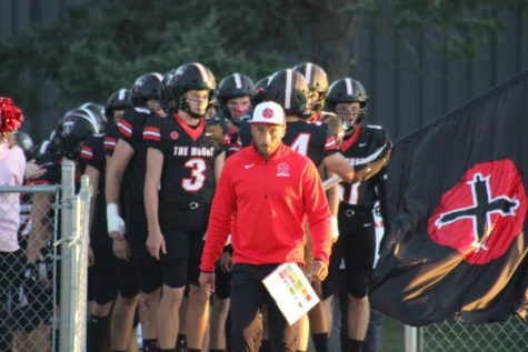 Leader of the Pack: Coach Allen Burell leads his team out of the lockerroom for their home game against the Blair Bears. Going into the game, the Knights had a 2-2 record.