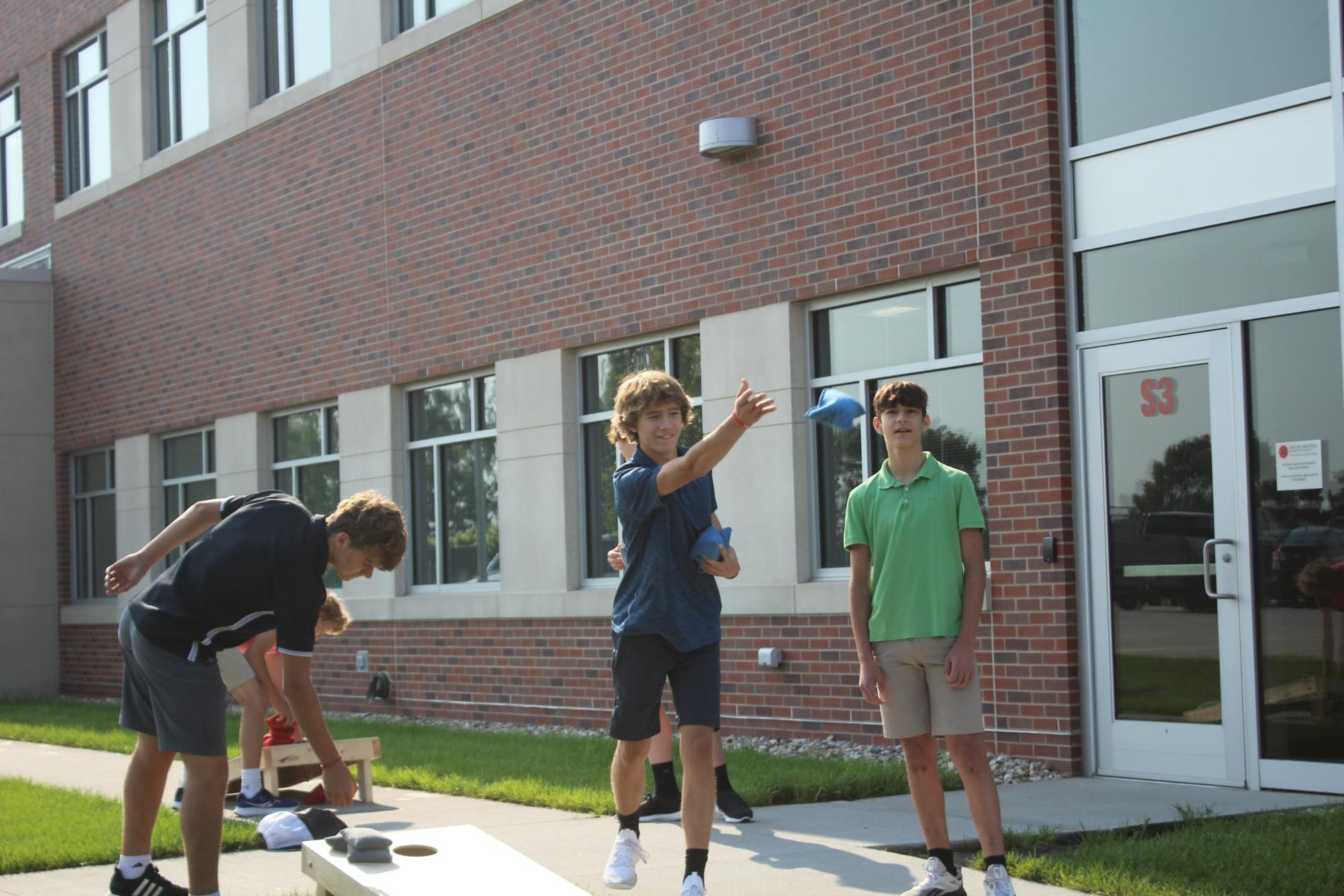 Noah Trueman 25 and Tony Newton 25 play cornhole during homeroom. Other homeroom events from the 2022-2023 school year included Christmas door decorating competitions and school-wide Kahoots.