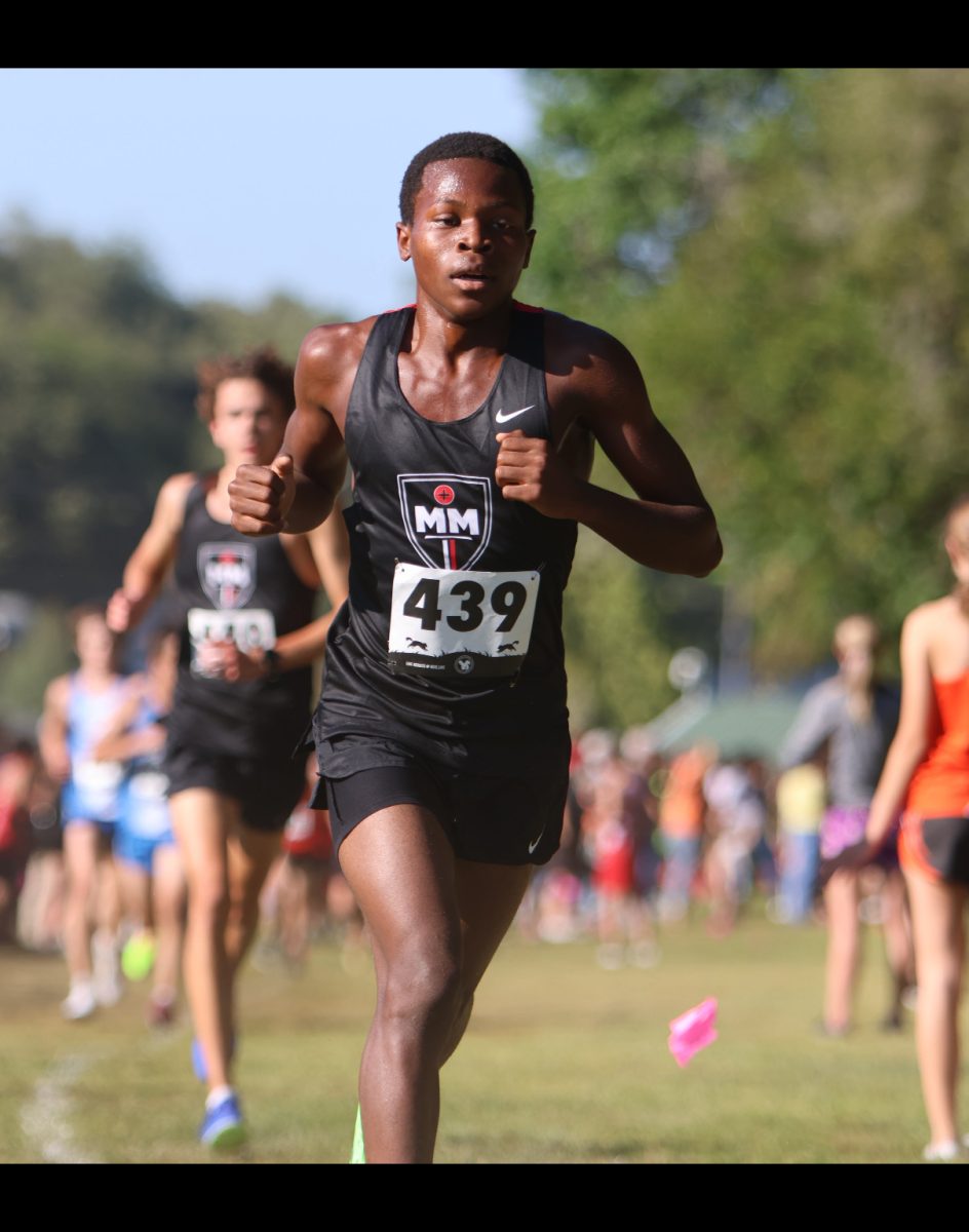 Finishing Strong Mesach Nkurubujango ‘27 runs the last few yards of  his race. Nkurubujango led the team to first place in the 2024  Plattesmouth Invitational race. Photo courtesy of Prep Running Nerd.